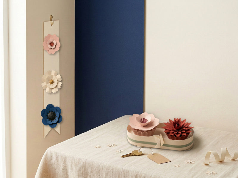 First home gift idea: Paper Flower Garland in Blush with Sakura, Daisy and Anemone on the wall, and a Paper Flower Bouquet Box with a Sakura and a Dahlia on the table
