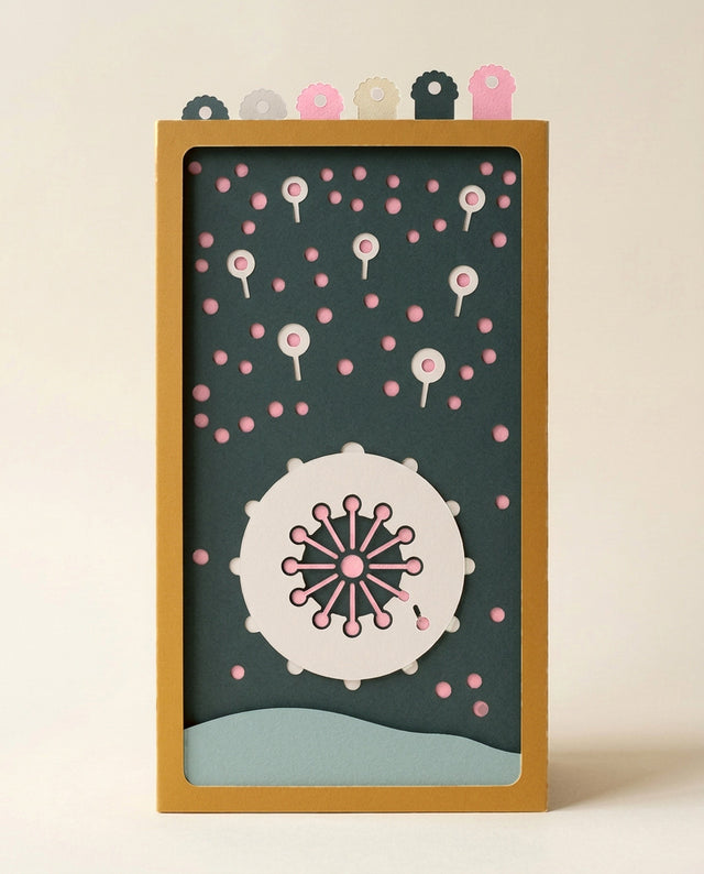 Mother's Love Pocket Story from the front: a white paper moon disc with a pink dandelion clock, seed balloons drifting across a teal paper sky over a sage dune, in a saffron sleeve with six puff tabs (AI-generated image)