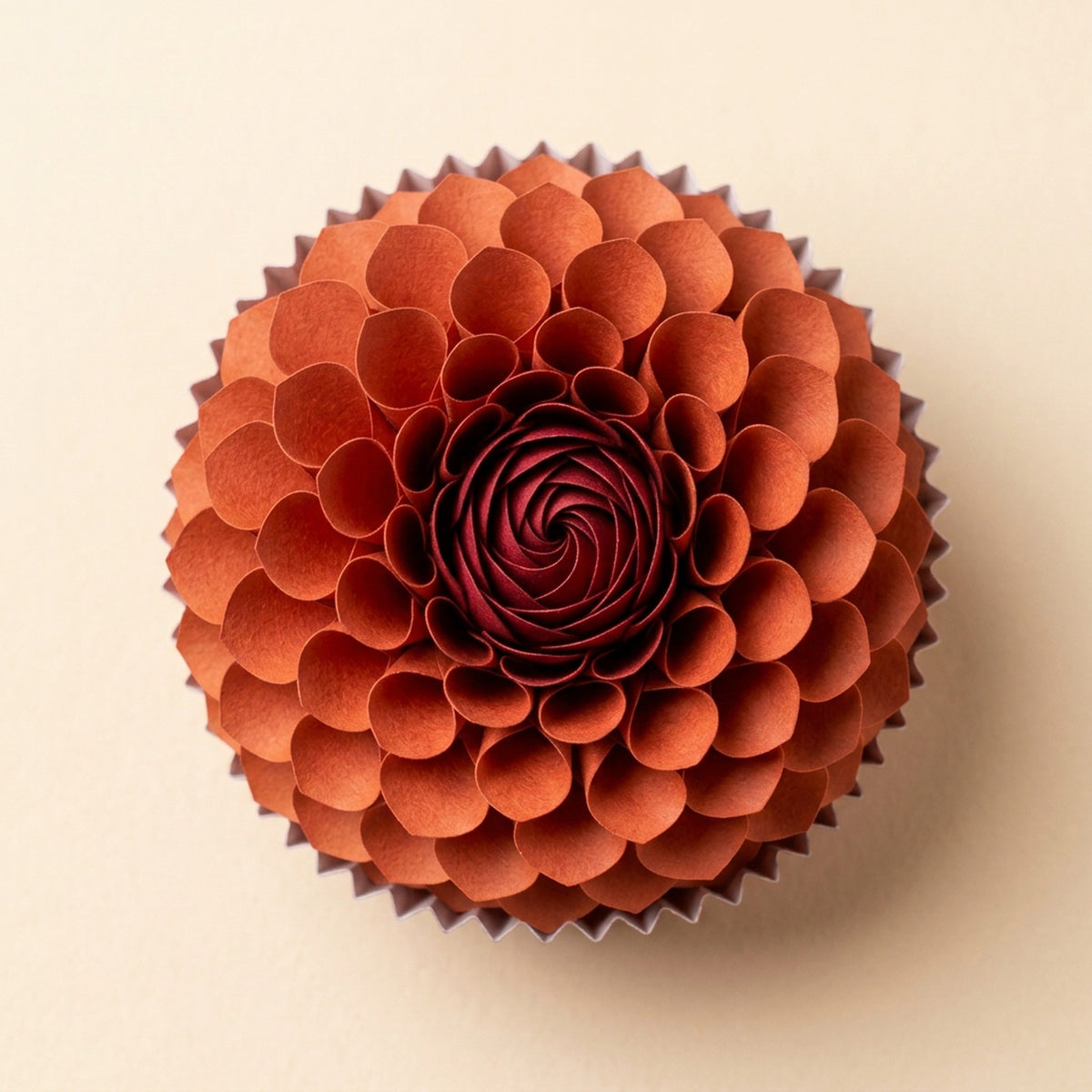[CONCEPT PLACEHOLDER] Dahlia paper flower in sumac red on its pleated paper cup, top-down view (AI concept image, not the final product)
