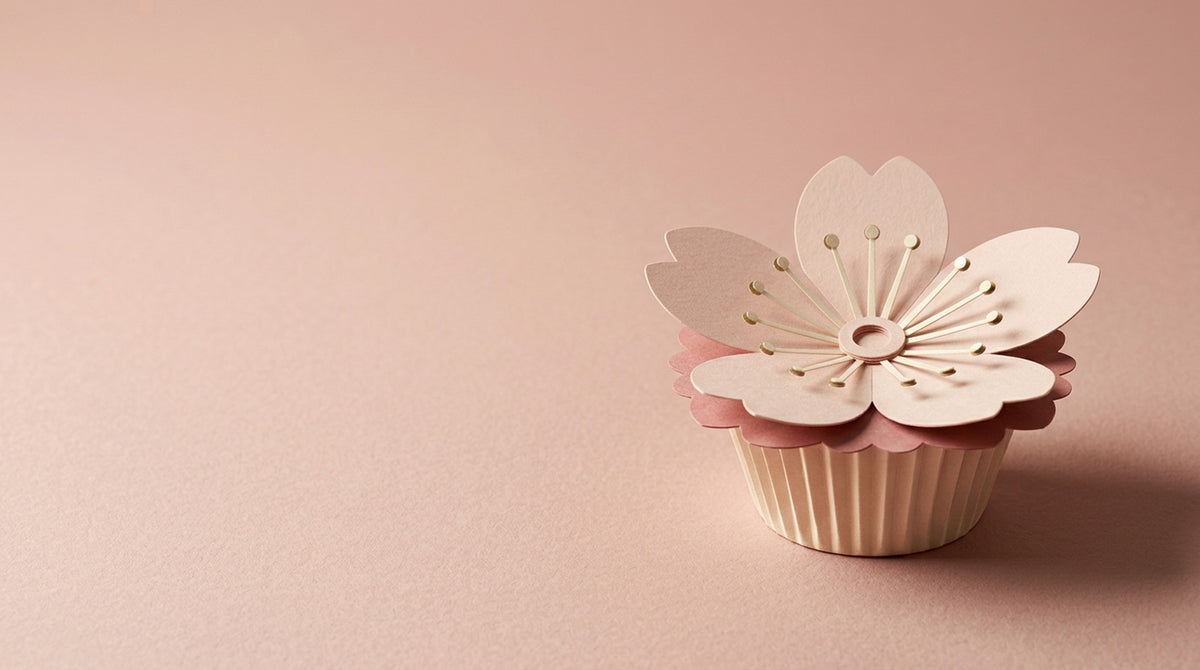 [CONCEPT PLACEHOLDER] Sakura paper flower in blush on its pleated paper cup, colour moment on a tonal paper background (AI concept image, not the final product)