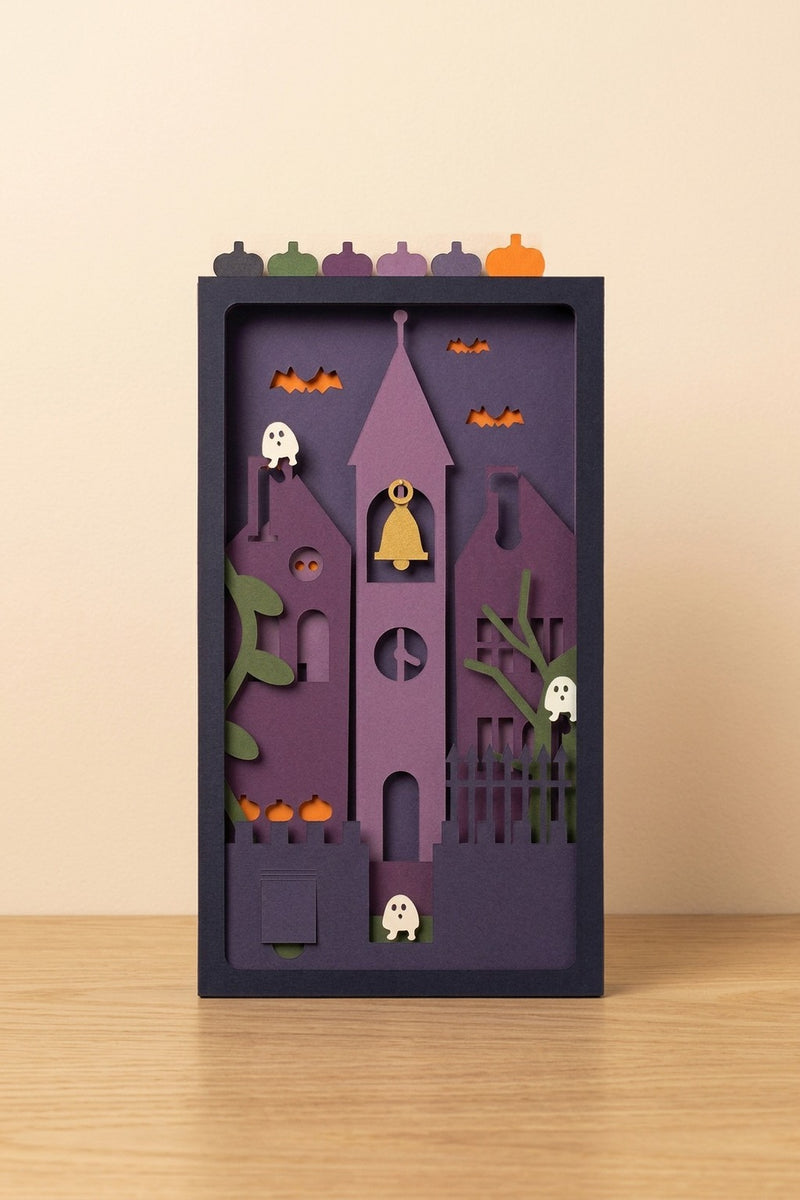 Halloween Invasion Pocket Story seen from the front: a violet bell tower, bats and ghosts, in a navy sleeve with six pumpkin tabs (AI-generated image)