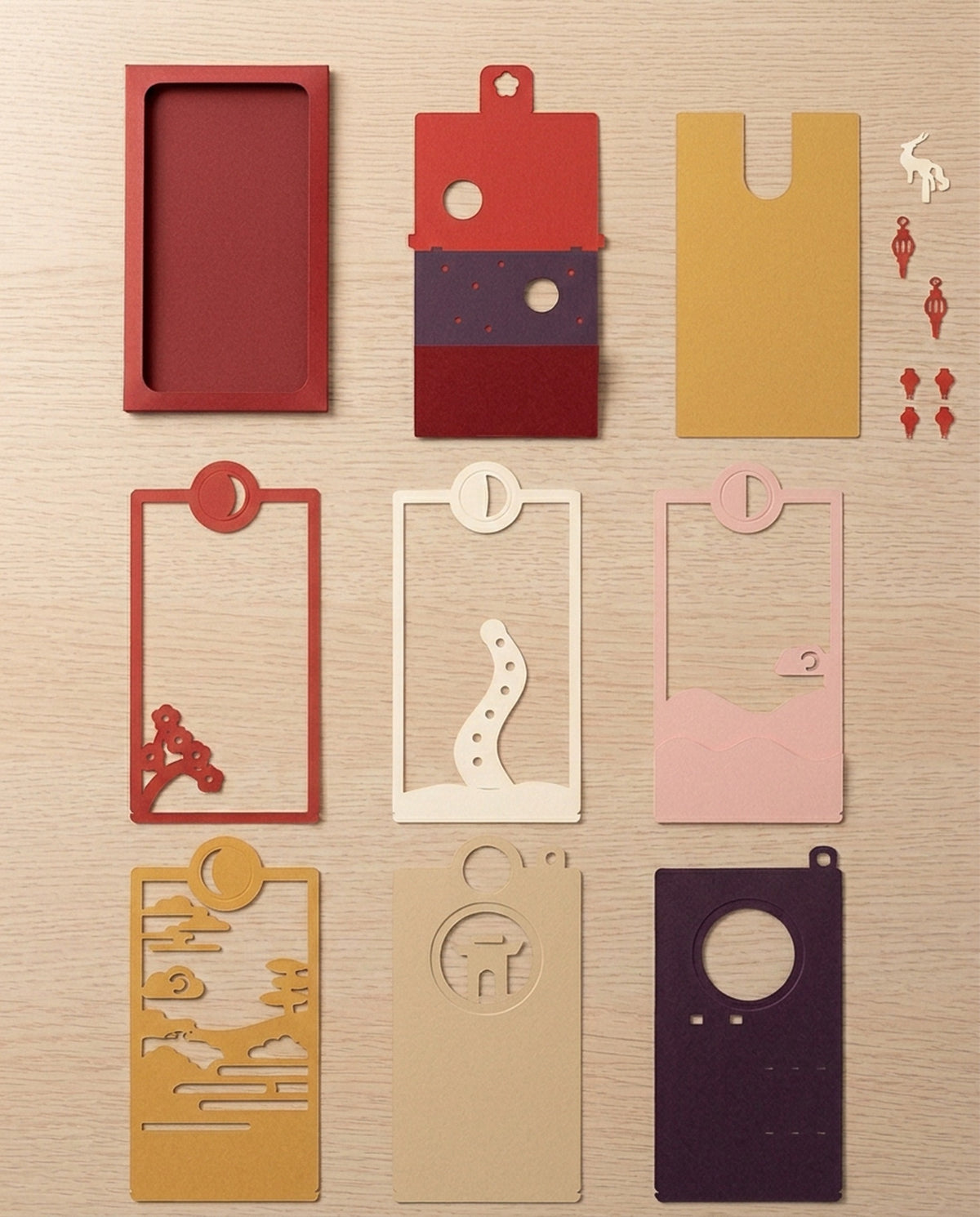 Every piece of the Year of the Goat Pocket Story laid flat: sleeve, cradle, six layers, Speeon and lanterns